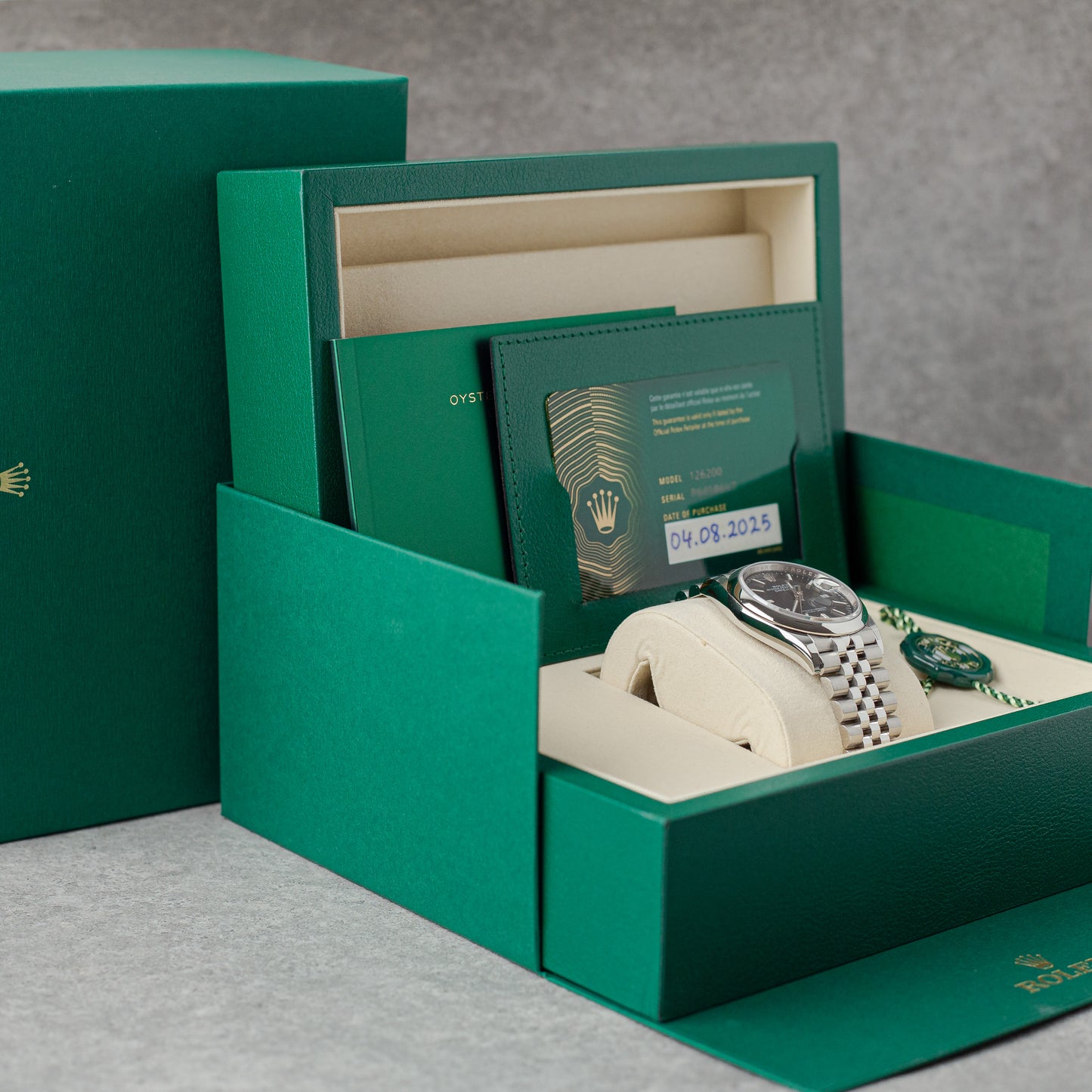 Rolex watch inside a green box with a gray background